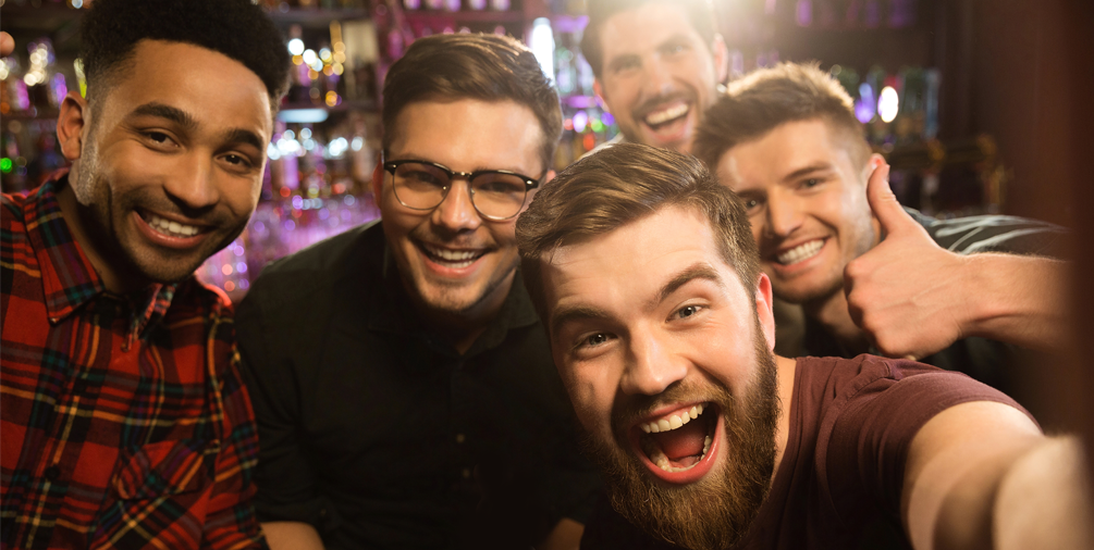 group of men smiling at bachelor party
