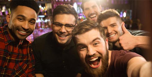 group of men smiling at bachelor party